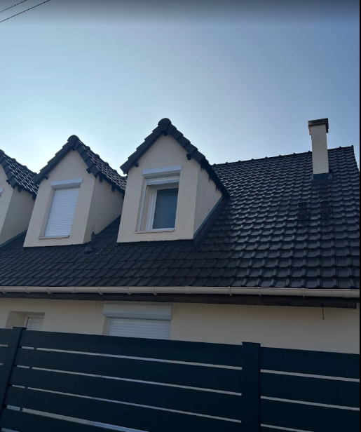 Toiture en ardoise noire avec deux lucarnes et cheminée réalisée à Villepinte (93420) par Toit de France